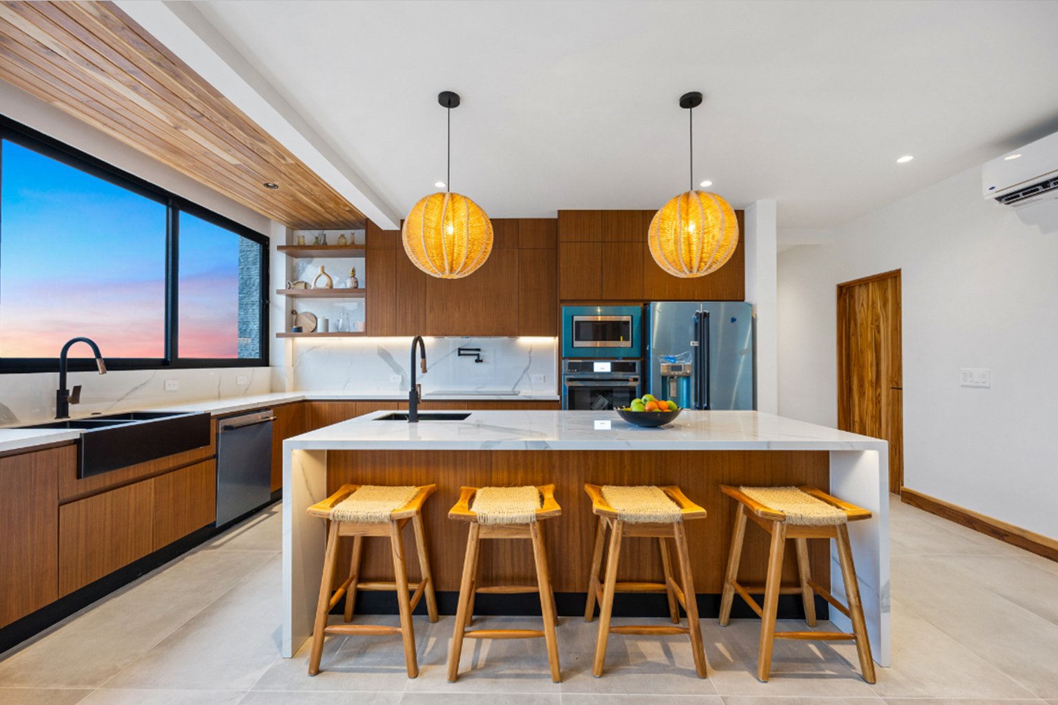 Custom wood kitchen cabinets by Mobilinea in a modern Guanacaste home